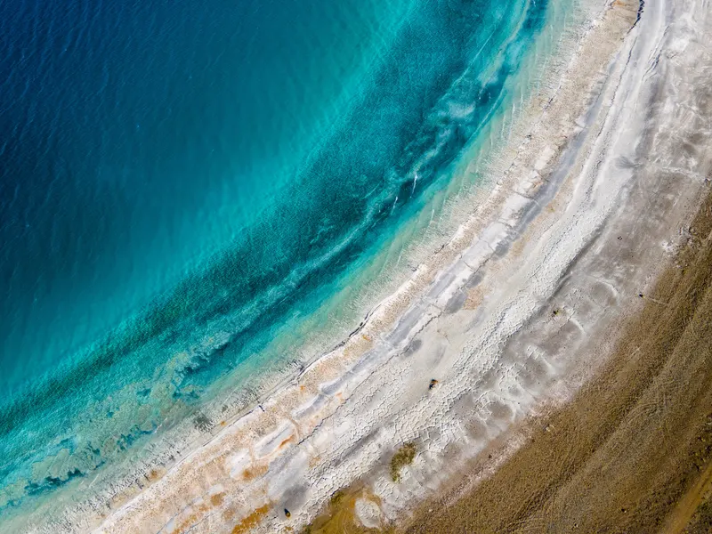 Aerial view of Salda Lake's white beach and turquoise shallows